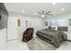This bedroom has a ceiling fan, 2 windows, and a massage chair at 1212 Princeton Ave, Bradenton, FL 34207