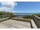 Wooden deck with railing offers stunning ocean views and bench seating for enjoying the outdoors at 1212 Princeton Ave, Bradenton, FL 34207
