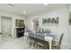 Bright dining room with tile floors, a white table, and views of the living spaces at 1212 Princeton Ave, Bradenton, FL 34207