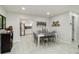 Bright dining room features modern decor, a view into the kitchen, and wood-look tile floors at 1212 Princeton Ave, Bradenton, FL 34207