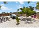 Wide angle view of the house and backyard including a driveway, trees and lawn with seating at 1212 Princeton Ave, Bradenton, FL 34207
