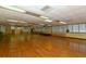 Spacious hall with hardwood floors, stage area, and ample natural light, ideal for events and gatherings at 1212 Princeton Ave, Bradenton, FL 34207