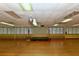 Large hall with stage, hardwood floors, and bright lighting; a versatile space for various activities at 1212 Princeton Ave, Bradenton, FL 34207