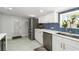 Updated kitchen with stainless steel appliances, white cabinetry, and modern backsplash at 1212 Princeton Ave, Bradenton, FL 34207
