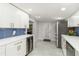 Bright kitchen featuring white cabinets, updated countertops, stainless steel appliances, and bar storage at 1212 Princeton Ave, Bradenton, FL 34207