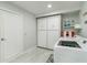 This laundry room has a side-by-side washer/dryer and storage shelves at 1212 Princeton Ave, Bradenton, FL 34207