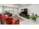 Inviting living room with a large TV, comfortable seating, a ceiling fan and neutral walls and flooring at 1212 Princeton Ave, Bradenton, FL 34207