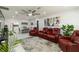 Open-concept living room with stylish seating, modern light fixtures, and neutral tile flooring at 1212 Princeton Ave, Bradenton, FL 34207