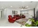 Well-lit living room with a modern ceiling fan, large TV, and comfortable seating at 1212 Princeton Ave, Bradenton, FL 34207