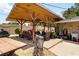 Wooden pergola structure with ceiling fans, with an outdoor seating area including a grill and sink at 1212 Princeton Ave, Bradenton, FL 34207