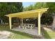 Outdoor picnic area featuring a bright yellow covered picnic table, ideal for enjoying meals outdoors at 1212 Princeton Ave, Bradenton, FL 34207