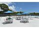 Community pool area featuring outdoor seating, umbrellas and lounge chairs, perfect for relaxing by the water at 1212 Princeton Ave, Bradenton, FL 34207