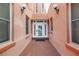 View of a private entrance to one of the condominiums with lovely windows and sconce lighting at 1221 N Palm Ave # 303, Sarasota, FL 34236