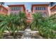 Charming condo building with lush tropical landscaping, secure gated entry, and classic architectural details at 1221 N Palm Ave # 303, Sarasota, FL 34236