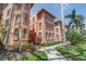 Charming condo community featuring lovely architecture, colorful facade, and verdant landscaping at 1221 N Palm Ave # 303, Sarasota, FL 34236