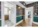 Hallway featuring unique wallpaper, hardwood floors, and access to the kitchen and living areas at 1221 N Palm Ave # 303, Sarasota, FL 34236