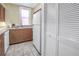 Bright kitchen area with wood cabinets, white appliances, and patterned tile flooring at 1221 N Palm Ave # 303, Sarasota, FL 34236
