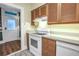 Functional kitchen with white appliances, wood cabinets, and direct access to the dining room at 1221 N Palm Ave # 303, Sarasota, FL 34236