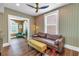 Bright living room decorated with unique wallpaper, neutral furniture, and access to other living spaces at 1221 N Palm Ave # 303, Sarasota, FL 34236