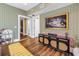 Living room showcasing patterned wallpaper, hardwood floors, and a decorative cabinet with a painting above at 1221 N Palm Ave # 303, Sarasota, FL 34236