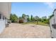 Spacious backyard with a basketball court, shed, and covered parking area at 12214 Hernando Rd, North Port, FL 34287