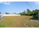 Large grassy backyard enclosed by a white fence, perfect for outdoor activities at 12214 Hernando Rd, North Port, FL 34287