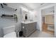 Bathroom featuring dual sinks, gray cabinets, modern lighting, and updated fixtures at 12214 Hernando Rd, North Port, FL 34287