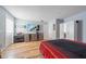 Bright bedroom featuring hardwood floors, a dresser, and closet with ample storage at 12214 Hernando Rd, North Port, FL 34287