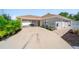 Attractive home exterior with a covered parking area and lush landscaping at 12214 Hernando Rd, North Port, FL 34287