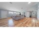 Bright living room with hardwood floors, a comfortable sofa, and large windows, creating a welcoming space at 12214 Hernando Rd, North Port, FL 34287