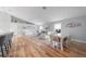 Open living and dining area with wood floors, light gray walls, and many windows at 12214 Hernando Rd, North Port, FL 34287