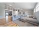 Spacious living room featuring a large gray sectional, hardwood floors, and abundant natural light, perfect for gatherings at 12214 Hernando Rd, North Port, FL 34287