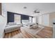 Stylish main bedroom with a seating area, ceiling fan, and modern decor at 12214 Hernando Rd, North Port, FL 34287