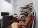 A comfortable office space with a desk, chair, computer, printer, and shelving unit, perfect for working from home at 12214 Hernando Rd, North Port, FL 34287
