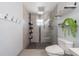 Modern tiled shower with glass enclosure, multiple shower heads, and built-in shelving at 12214 Hernando Rd, North Port, FL 34287