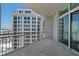 Spacious balcony with tile flooring overlooking a cityscape and a modern high-rise building at 1350 Main St # 1703, Sarasota, FL 34236