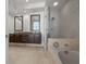 Spa-like bathroom featuring double vanities, a soaking tub, and a glass-enclosed shower at 1350 Main St # 1703, Sarasota, FL 34236