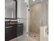 Modern bathroom featuring a glass shower, granite countertop and a dark wood vanity cabinet at 1350 Main St # 1703, Sarasota, FL 34236