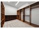 Walk-in closet with custom wood shelving and soft carpeting, providing ample storage space at 1350 Main St # 1703, Sarasota, FL 34236