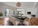 Open-concept dining area featuring a modern table setting, contemporary lighting, and a view to the living room at 1350 Main St # 1703, Sarasota, FL 34236