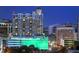 Exterior night shot of the high-rise building showing the many lights and parking structure at 1350 Main St # 1703, Sarasota, FL 34236