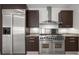 Modern kitchen features stainless steel appliances, granite countertops, and dark wood cabinets at 1350 Main St # 1703, Sarasota, FL 34236