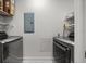 Laundry room featuring modern washer and dryer units with white wire shelving at 1350 Main St # 1703, Sarasota, FL 34236