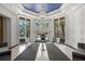 Elegant lobby with a large chandelier, black and white tiled floor, potted plants, and seating at 1350 Main St # 1703, Sarasota, FL 34236