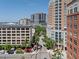 An urban streetscape with a blend of modern and classic buildings, lush greenery, and vibrant street-side cafes at 1350 Main St # 1703, Sarasota, FL 34236