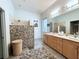 Spacious bathroom featuring a double vanity, walk-in shower with stone accent wall, and woven basket at 13809 18Th E Pl, Bradenton, FL 34212