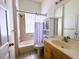 Bathroom with a combined tub and shower, a decorative shower curtain and a white vanity at 13809 18Th E Pl, Bradenton, FL 34212