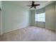 Light green bedroom with a ceiling fan and a window with white shutters at 13809 18Th E Pl, Bradenton, FL 34212