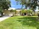 Beautiful single-story home with a manicured lawn, palm trees, and attached two-car garage at 13809 18Th E Pl, Bradenton, FL 34212