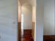 Hallway with wooden floors and storage cabinets on the side leading to another room at 13809 18Th E Pl, Bradenton, FL 34212